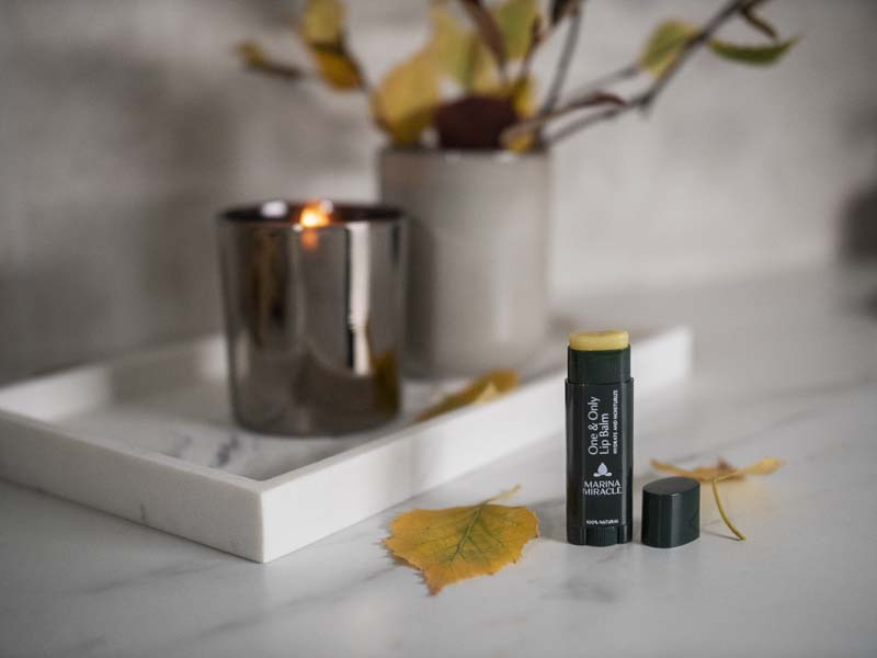 Natural & organic lip balm with autumn leaves and a cosy candle